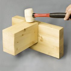 a person using an electric hammer to block out wood pieces on a table or bench