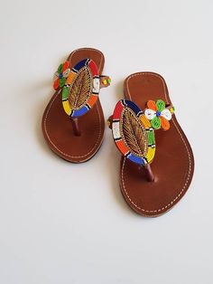 Maasai sandals made with high quality leather and colorful fine beads. * We also take wholesale orders* Perfect for outdoor summer events , beach wear , festivals , African themed events etc. Buy multiple items and pay shipping for one item Only. Back to my shop; https://www.etsy.com/shop/TribalTess?ref=seller-platform-mcnav Traditional Multicolor Barefoot Sandals For Vacation, Traditional Multicolor Sandals With Round Toe, Multicolor Round Toe Sandals For Festivals, Multicolor Leather Toe Post Sandals, Handmade Multicolor Open Toe Barefoot Sandals, Multicolor Single Toe Strap Sandals For Festivals, Multicolor Toe Ring Sandals For Festival, Multicolor Toe Ring Sandals With Single Strap For Festivals, Multicolor Round Toe Toe Ring Sandals For Festivals