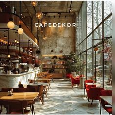 the interior of a restaurant with lots of tables and chairs in front of large windows