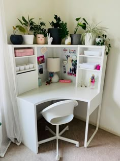 a white corner desk with plants on top