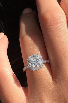 a woman's hand with a diamond ring on it