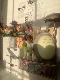 an assortment of toys sitting on top of a desk