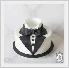 a white and black cake with a tuxedo on top