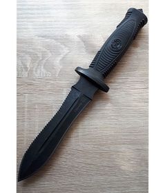 a black knife sitting on top of a wooden table