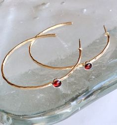 Hammered garnet hoops Classic Hoop Earrings With Bezel Setting, Classic Bezel Set Hoop Earrings As Gift, Classic Bezel Set Hoop Earrings, Classic Bezel-set Hoop Earrings, 14k Gold Birthstone Hoop Jewelry, 14k Gold Hoop Earrings With Bezel Setting, Gold Garnet Jewelry With Bezel Setting, 14k Gold Hoop Earrings With Bezel Setting For Anniversary, Garnet Birthstone Jewelry In Round Shape