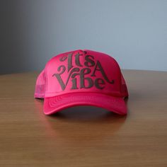 Add some personality to your headwear game with the It's A Vibe Foam Trucker hat! This fun and quirky hat will bring good vibes and a unique style to any outfit. The foam trucker design adds a touch of whimsy, making it a perfect accessory for those who like to stand out. Trust us, it's a vibe. A Montana Scene Original Design. All designs are property of The Montana Scene. All rights reserved. All of The Montana Scene apparel is designed and printed locally in Montana. Come visit our storefront Fun Summer 5-panel Trucker Hat, Novelty Pink Trucker Hat For Summer, Summer Trucker Hat With Smiley Face, Summer Beach Trucker Hat, 5-panel, Summer Beach Trucker Hat, 5-panel Design, Kids Onesies, Bath Gift, Kids Beanies, Sock Gifts