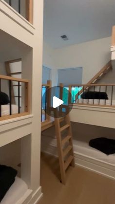 a room with bunk beds and ladders in it