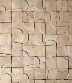 a close up of a tile wall with different shapes and sizes on it's surface