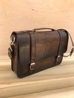 "Top Grain leather Messenger Bag, Great gift for husband, son, boyfriend, groomsman or for any occasion such as Anniversary, Birthday, Promotional celebration,etc. DESIGN - practical and elegant, this authentic leather messenger bag perfect for a modern man. DIMENSIONS: W 16 in. x D 4 in. x H 12 in. ,shoulder strap: L 30 in. - 35 in + MATERIALS * Exterior made from genuine TOP-grain cowhide that will last you for decades * Interior fully lined with cotton and easy to clean * Hand-dyed using the Classic Handmade Leather Satchel, Handmade Leather Briefcase In Brown, Handmade Brown Leather Briefcase, Handmade Rectangular Leather Briefcase, Handmade Leather Rectangular Briefcase, Handmade Leather Briefcase For Everyday Use, Men's Leather Briefcase, Distressed Leather Bag, Leather School Bag