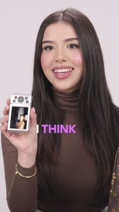 a woman holding up a camera with the words think above her