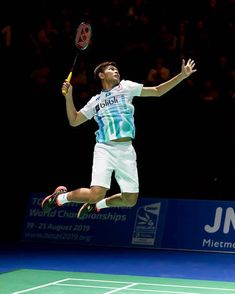 a tennis player jumping in the air to hit a ball with his racquet