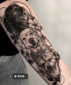 an arm tattoo with three dogs and flowers on the left side of the arm, in black and white