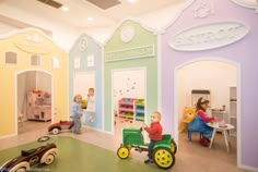 two children playing with toys in a playroom