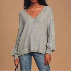 Personal Record Heather Grey Knit Balloon Sleeve Sweater Top

New without tag
Soft and stretchy waffle knit shapes this oversized sweater top with a deep V-neckline, long balloon sleeves with drop shoulders, and a wide-cut boxy bodice. Ribbed detail accents the neck, cuffs, and hem, adding a chic contrasting effect. Oversized silhouette makes this top perfect for layering over a cute sports bra or bralette!
Unlined and slightly sheer.
Shell & Contrast: 48% Polyester, 48% Rayon, 4% Spandex.
H Strip Blouse, Cute Sports Bra, Personal Record, Balloon Sleeve Sweater, Leather Bustier, Denim Crop Top, Body Suit With Shorts, Striped Bodysuit, Embellished Blouse