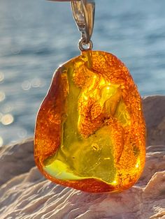 Pendant material and details : * Natural Baltic amber * Type of Amber: Transparent * Color of Amber: Honey, Cognac * Metal : 24K gold plated sterling silver 925 * Size of pendant : 5,0 * 3,0 cm Amber Pendant, Natural Amber, Raw Honey, Baltic Amber, Gold Plated Sterling Silver, Sterling Silber, Pendant Necklaces, Cognac, Silver 925