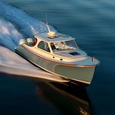 a small white boat speeding across the water