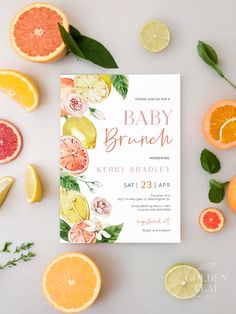 the baby brunch is surrounded by citrus slices and leaves, including oranges