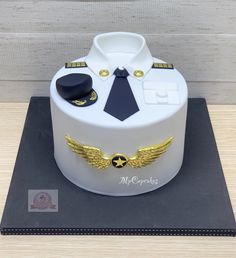 a cake made to look like an air force officer's uniform with gold wings