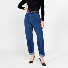 Vintage 80s high waisted mom jeans by Lee in a dark wash denim, with a pleated front and a tapered leg. Shown cuffed, and modeled with a belt in the first two photos (not included with purchase).   Measurements and Condition: Fits like: Labeled size 14, but fits modern women's medium Fabric: Cotton denim Brand: Lee Riders, made in USA Condition: Very good, with light general wear Waist: 28.5" Hips: 42" - taken at the bottom of the zipper opening Rise: 13.5" Inseam: 31"  Shown on a 5'8" model with measurements of 35"-26"-38", usually wears a size small to medium. See our FAQ for more info on sizing and condition ratings. High Waisted Mom Jeans, Midi Skirt Outfit, Jeans Mom, Jean Vintage, Jumpsuit Shorts Rompers, Denim Branding, Dark Wash Denim, Short Jumpsuit, Swimwear Accessories