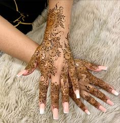 two hands with henna designs on them