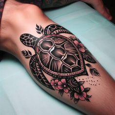 a tattoo on the leg of a person with a turtle