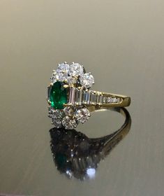 DeKara Designs Classic Handmade Art Deco Oval Emerald and Diamond Ring. Metal- 18K Yellow Gold, .750 Stones- 1 Oval Natural Green Colombian Emerald 0.81 carats, 22 Round Diamonds, 10 Baguette Diamonds, F-G Color VS2 Clarity 2.85 Carats. Art Deco inspired 18K Yellow Gold Diamond Colombian Emerald Engagement Ring. The ring features a beautiful green Colombian Emerald, that is truly an exceptional color and quality. There are five baguette diamonds on each side of the emerald that are prong set, an Diamond Emerald Ring, Art Deco Emerald, Emerald And Diamond Ring, Baguette Diamonds, Colombian Emeralds, Emerald Engagement, Diamond Wedding Ring, Art Deco Engagement Ring, Ring Metal