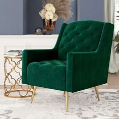 a green velvet chair sitting on top of a white rug