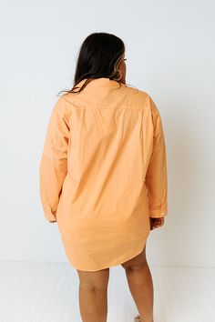 Channel all the good luck on your special day with this casual cute orange plus size top featuring lightweight material, a button up front with a collared neckline, long loose sleeves with roll tab cuffs, a single accent chest pocket, and a relaxed silhouette that falls into a rounded hemline!   Measurements 1XL variant has  a Bust of 58",  a Hip of 54",  a Length of 35",  a Sleeve Length of 15",  a Waist of 53".  2XL variant has  a Bust of 60",  a Hip of 55",  a Length of 36",  a Sleeve Length Long Sleeve Peach Blouse For Fall, Peach Long Sleeve Blouse For Fall, Oversized Long Sleeve Orange Blouse, Orange Fall Blouse For Daywear, Fall Orange Blouse For Daywear, Oversized Orange Long Sleeve Blouse, Orange Long Sleeve Blouse With Relaxed Fit, Orange Relaxed Fit Long Sleeve Blouse, Accent Chest