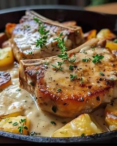 pork chops with potatoes and gravy in a skillet