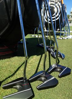 several golf clubs are lined up on the grass