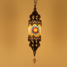 a hanging light with a colorful design on it