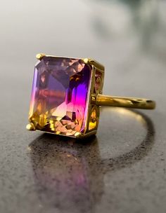 Look different and outstanding with our beautiful ametrine ring. Set on a polished band crafted in 14K gold plating over sterling silver this emerald-cut gemstone flashes a color gradient of purple and yellow. Ametrine is believed to be tthe stone of connection and balance. Wear it everyday to stimulate your creativity and self-confidence. Artist Identity, Jewellery Emerald, 18k Gold Engagement Ring, Cool Rings For Men, Morganite Jewelry, Dope Jewelry, Color Gradient