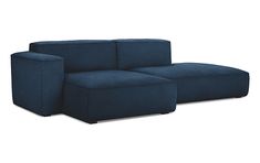 a blue couch sitting on top of a white floor next to a chair and ottoman