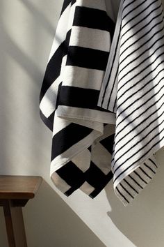 two black and white towels hanging on the wall