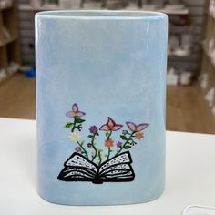 Oval vase painted at Crafty Monkey Pottery Painting studio with a book and flower design. Fancy Painting, Christmas Pottery, Oval Vase, Thick Base, Paint Your Own Pottery, Spoon Rests, Functional Pottery, Painting Studio, Pottery Ideas