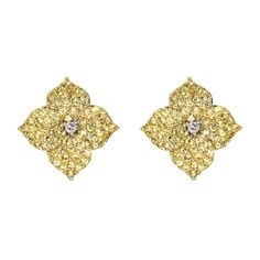 two tone gold earrings with diamonds in the shape of an ornament, on a white background