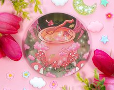 a glass plate sitting on top of a pink surface next to flowers and other decorations