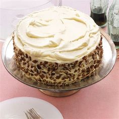 a cake sitting on top of a table next to a plate with a knife and fork