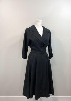 "Elegant black raw silk dress with great 1950s details. Lovely silhouette with one large button (and a bound buttonhole!) on the bodice as well as snaps and hooks inside. The collar and lapel are wide and fantastic. 3/4 dolman sleeve. Waist seam with pleats at the side front and back panels but flat in the front. The lining is a cheerful pale yellow silk. No label, handmade. Condition is great. The lining has some stains and discoloration as well as holes from wear and age under each underarm. R Vintage A-line Dress For Work, 1950s Style Formal Dresses With Buttons, Formal Vintage Dress With Full Skirt, 1950s Style Buttoned Dresses For Work, Retro Evening Dresses With Buttons, 1950s Style Vintage Dress For Work, Vintage Evening Dresses With Buttons, Raw Silk Dress, Black Suspenders