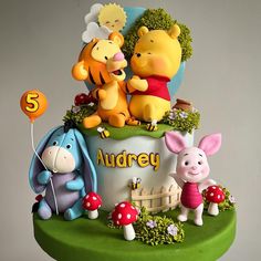 a birthday cake made to look like winnie the pooh and friends