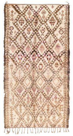 an old rug with fringes on the bottom and sides, in brown tones is shown