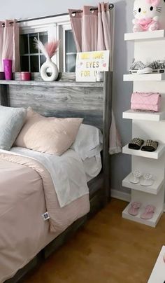 a bedroom with pink and white accessories on the headboard, shelves above the bed