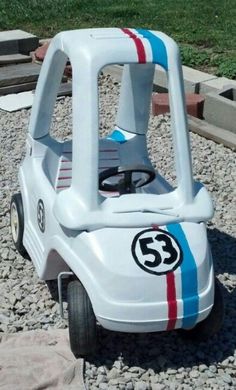 a small toy car sitting on top of gravel