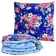 a blue flowered pillow and blanket are next to each other