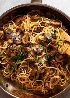 pasta with mushrooms and parmesan cheese in a pan