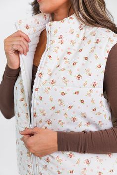 Details Ivory Floral Puffer Vest Fabric has no stretch Collared style, full zip closure, functional pockets Pair this vest over a cute basic long sleeve tee! Lined Size small from shoulder to hem: 19" Material and Care 100% polyester Machine wash cold, no drum drying Patterns may vary Materials may have natural variations Colors may vary from different viewing devices. White Stretch Tops With Pockets, White Casual Vest For Spring, Trendy White Spring Vest, Trendy Spring Vest With Zipper Closure, White Spring Vest With Pockets, White Spring Outerwear For Layering, White Vest With Pockets For Spring, White Fall Vest Outerwear, White Outerwear For Spring Layering