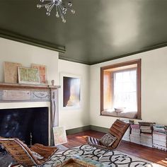 a living room filled with furniture and a fire place in front of a large window