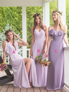 three bridesmaids in lavender dresses posing for a photo on the porch with their bouquets