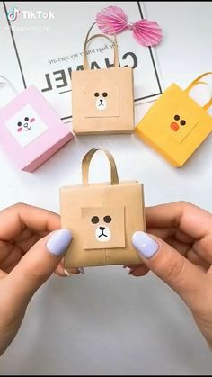 someone is holding up some paper bags with faces on them, and the bag has been made to look like a bear