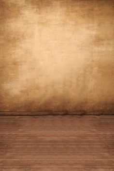 an empty room with wooden floors and a brown wall